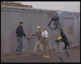 bat man runs humorously with a bomb